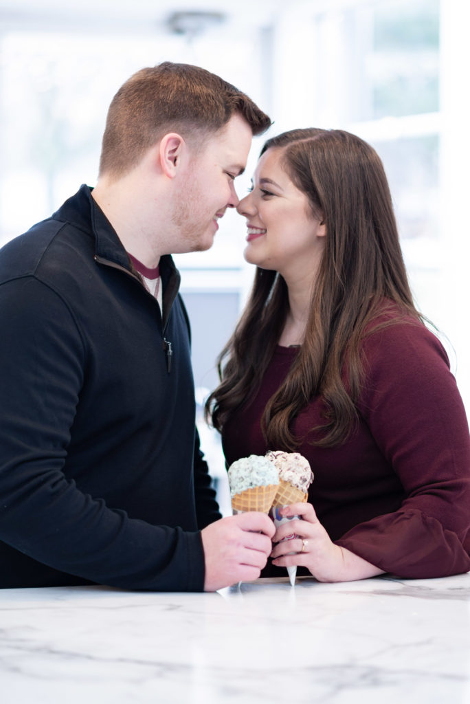 LocationGorgeous couple enjoying one another and ice cream together celebrating their engagement