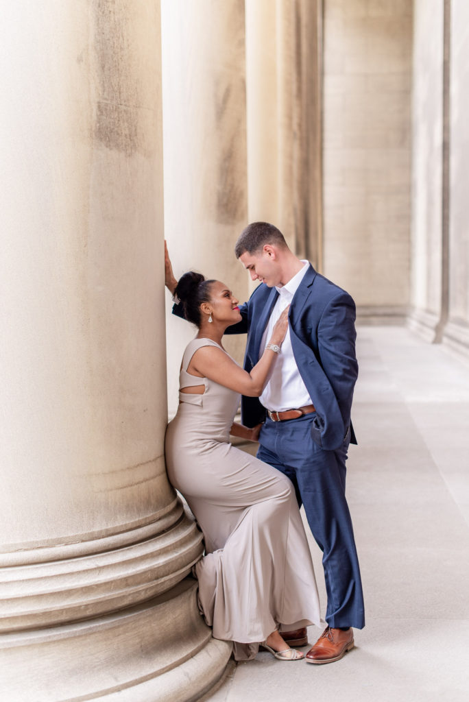 Location of engagement session matters.Beautiful couple all dressed up among the columns of the Mellon Institute of Industrial Research in downtown Pittsburgh
