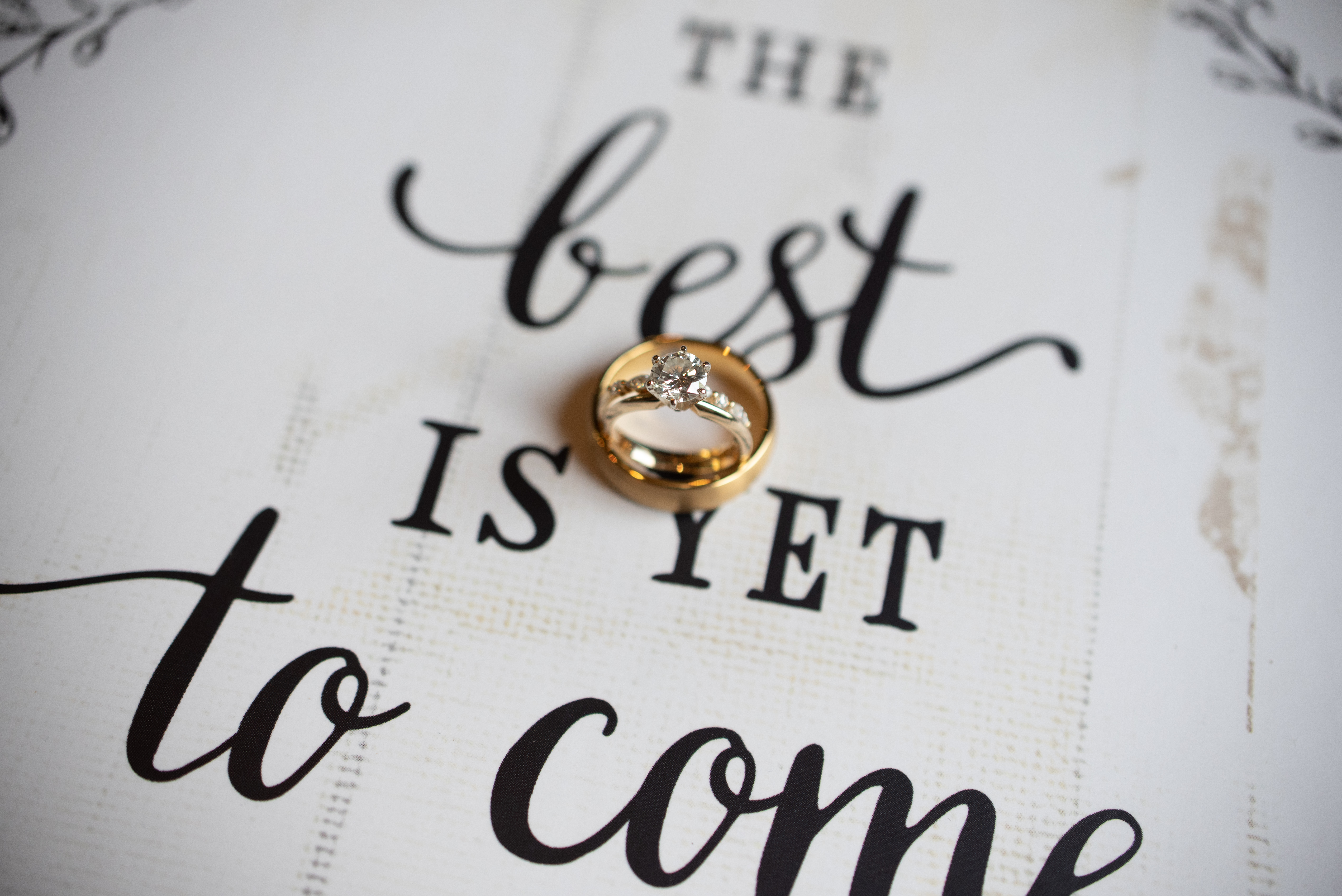 Wedding rings over text that reads "the Best is yet to come"